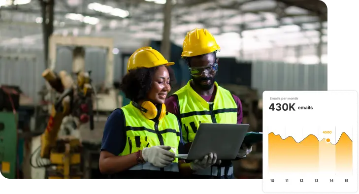 Two construction professionals reviewing information on a tablet in an industrial setting, with a graph showing email statistics overlayed.