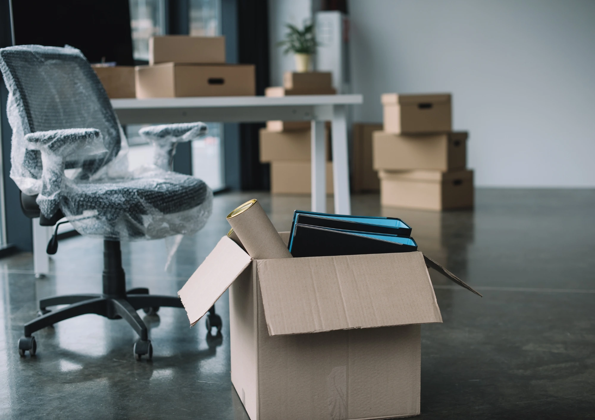 An office space during a move with boxes filled with equipment