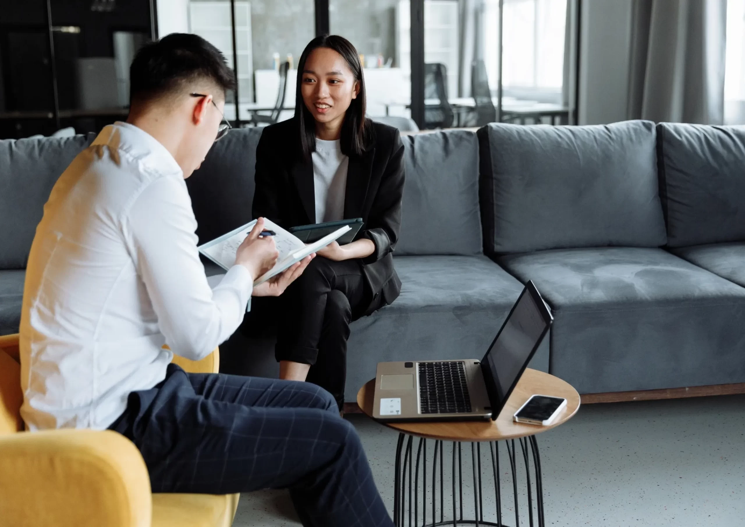 Two business professionals are deeply engaged in a discussion over documents in the office